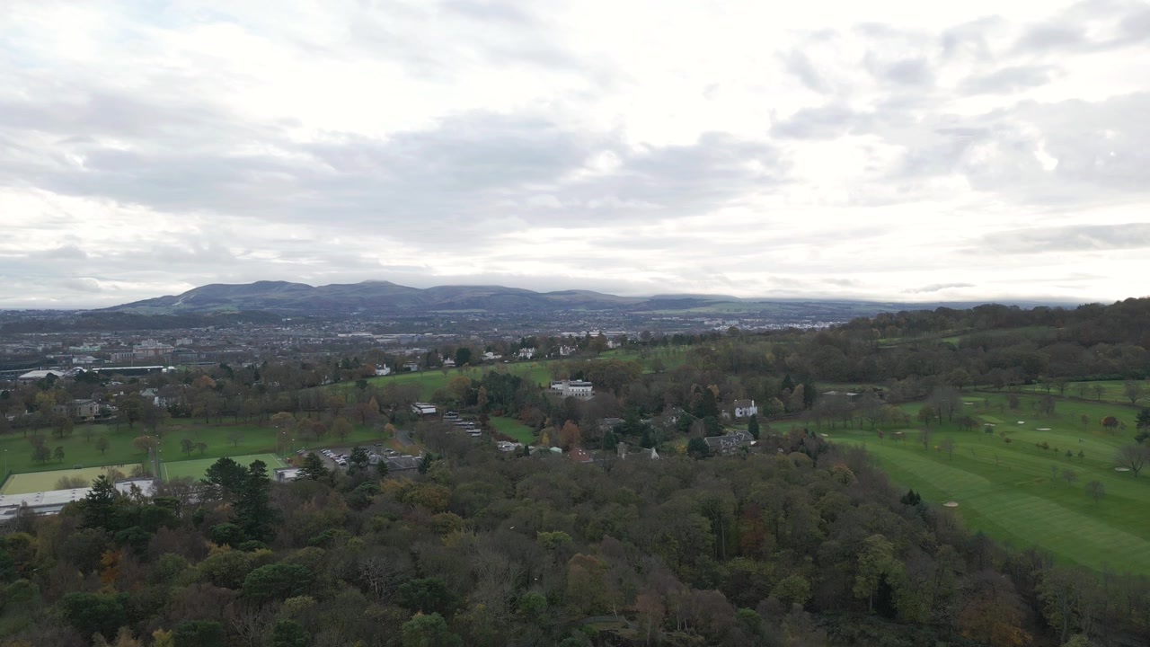 Aerial Rising To Reveal Golf Course Surrounded By Woods