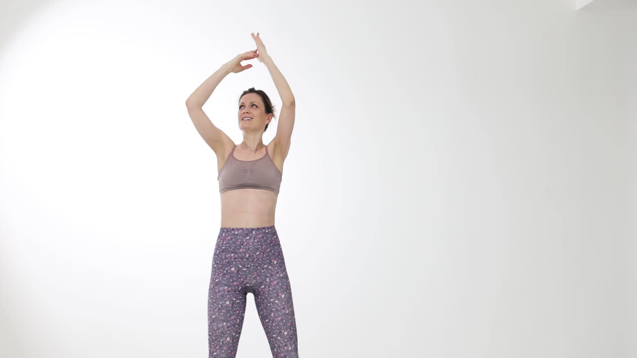 Woman performing yoga or stretching exercises in a studio