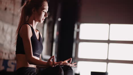 beautiful young woman in sportswear practicing yoga at fitness studio