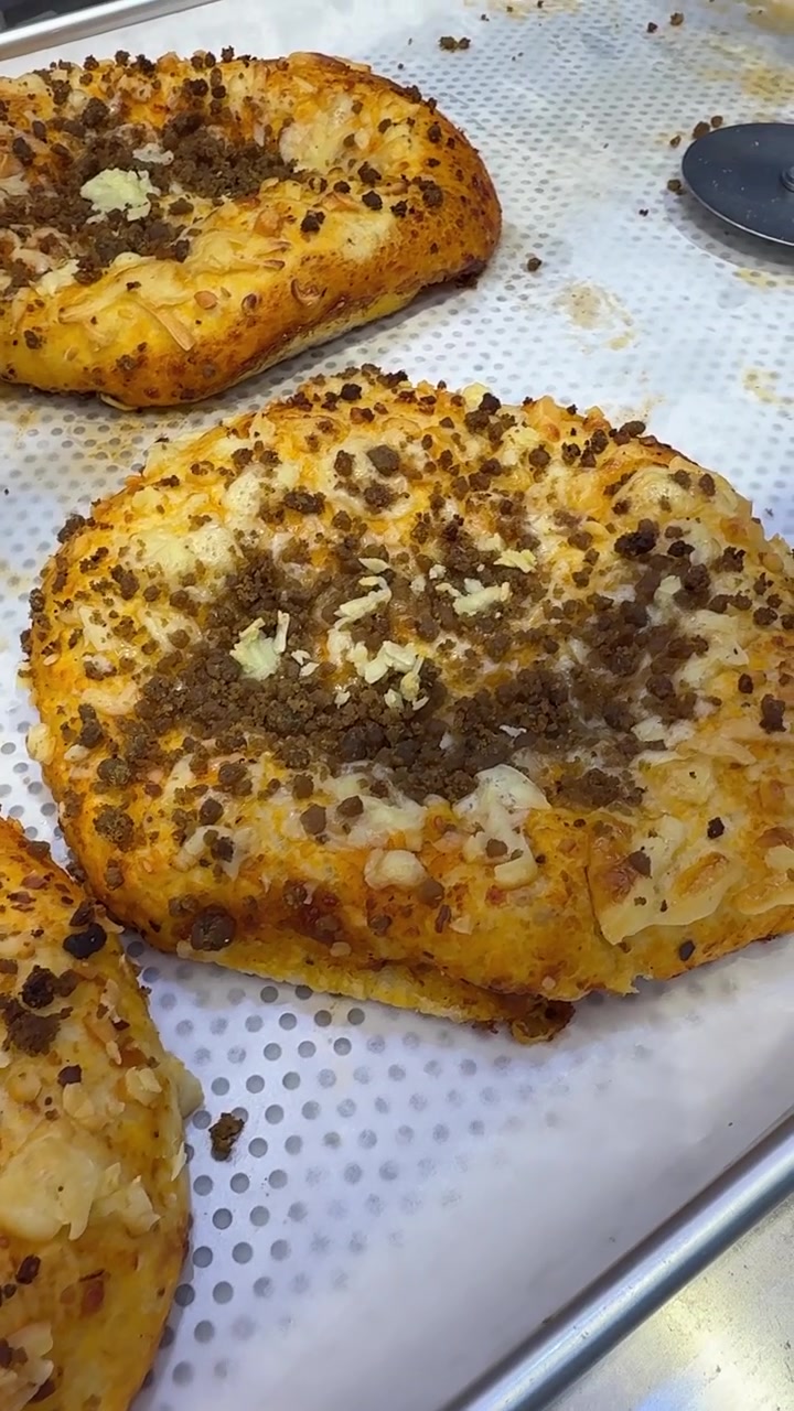 Freshly Baked Savory Meat and Cheese Pastries on a Baking Tray