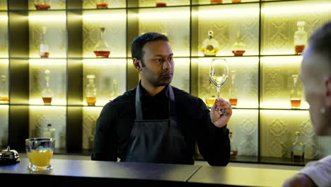 bartender cleaning a cup