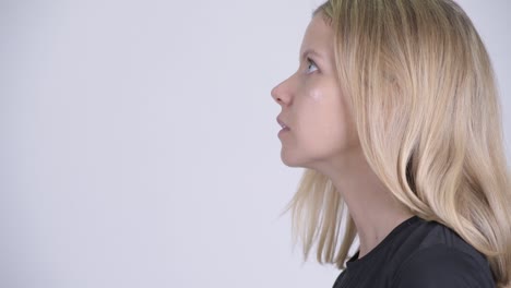 closeup profile view of young beautiful woman with blond hair