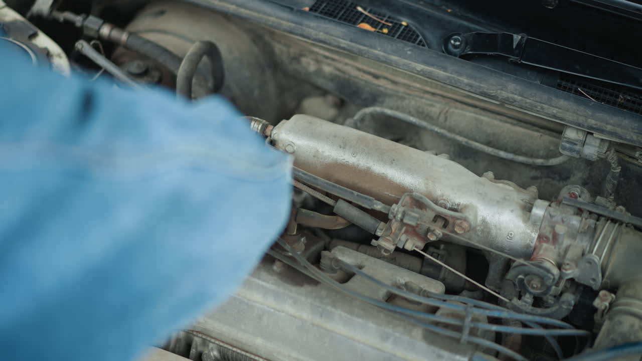 Mechanic examines engine, Automotive technician analyzing worn out ...
