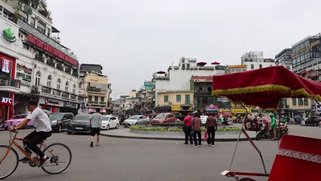 pedestrians and vehicles crossing a busy city square