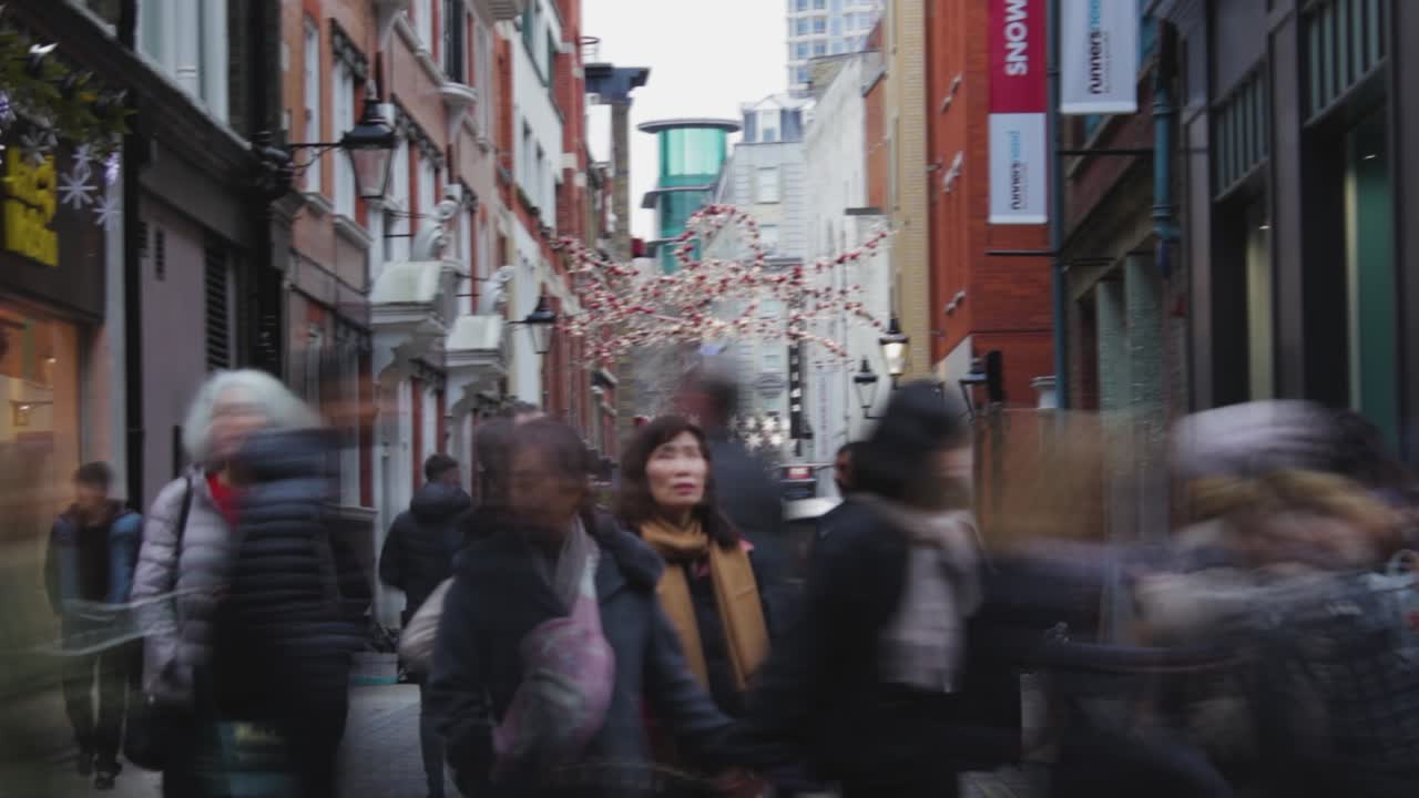 Time lapse of crowds of people walking on busy shopping street, Christmas time. London, United Kingdom