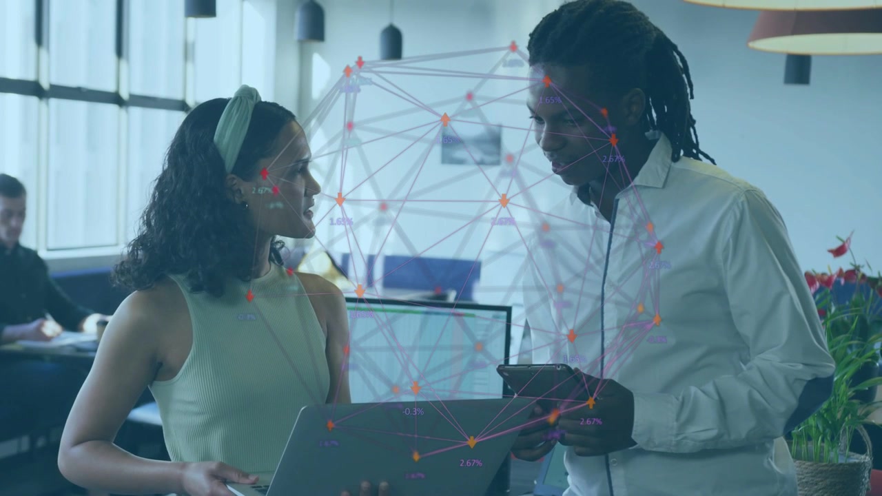 Woman pointing at laptop screen man using tablet and checking data business overlay linking devices