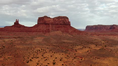 Aerial-approach-towards-massive-sandstone-buttes-in-red-sand-desert-in-Arizona