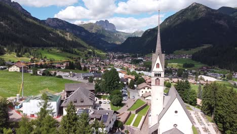 vigo di fassa at fassa valley , trentino, dolomites, italy - aerial drone view of the picturesque mountain village