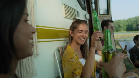 friends spending time on the camping side and drinking beer.