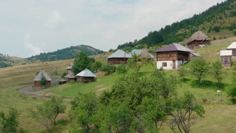 old traditional houses at sopotnica village on jadovnik mountain in serbia - aerial drone shot