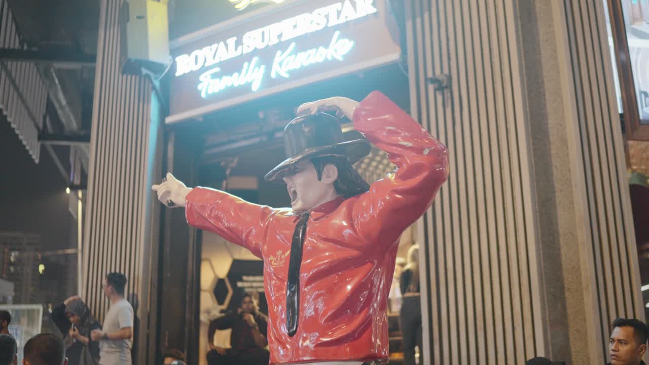 Michael Jackson statue on streets of Kuala Lumpur, Malaysia in front of a restaurant.