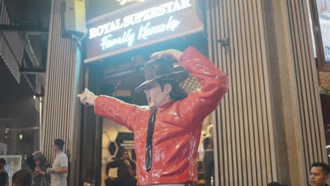 michael jackson statue on streets of kuala lumpur, malaysia in front of a restaurant.