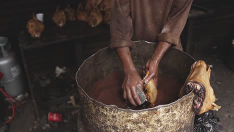 african man washing the meat