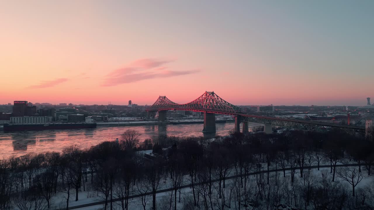 aerial shot above Jean Drapeau park in Montreal with Jacques Cartier brisge in the background at sunset, Quebec province, Canada
