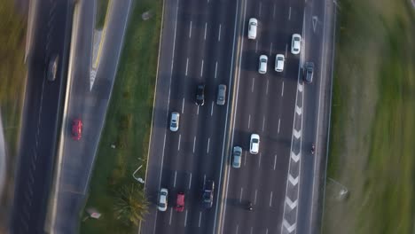 a dynamic pivoting top-down aerial footage above a busy four-lane highway in buenos aires city