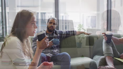 in modern office, people drinking coffee and talking with city view