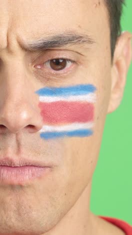 serious man with a costa rican flag painted on the face