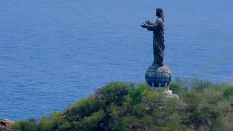 the popular tourism landmark cristo rei of dili jesus statue with blue ocean in the capital, timor leste, south east asia