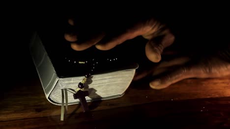 praying to god with hands together with bible and cross caribbean man praying with black background stock video