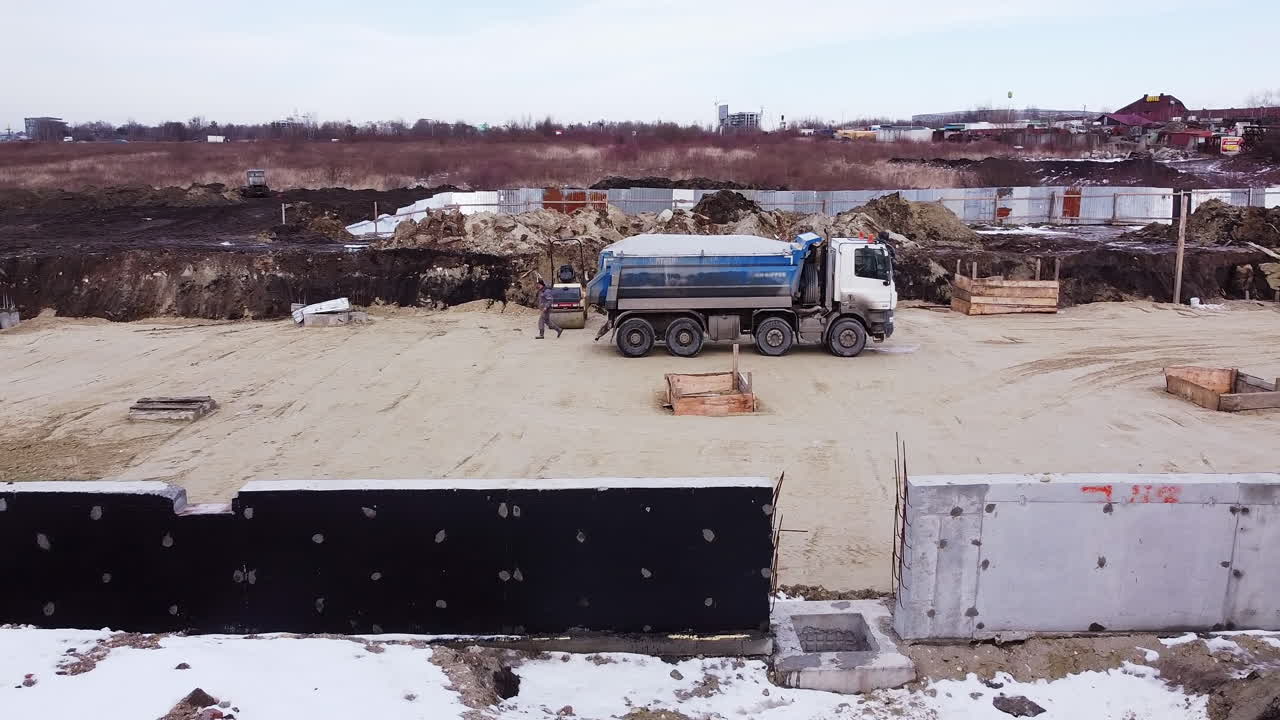 Construction Site with Dump Truck and Workers