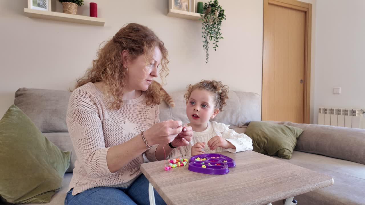 Mother and Daughter Playing with Beads