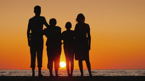 Glückliche-Mehrgenerationenfamilie,-Die-Den-Sonnenuntergang-über-Dem-Meer-Genießt