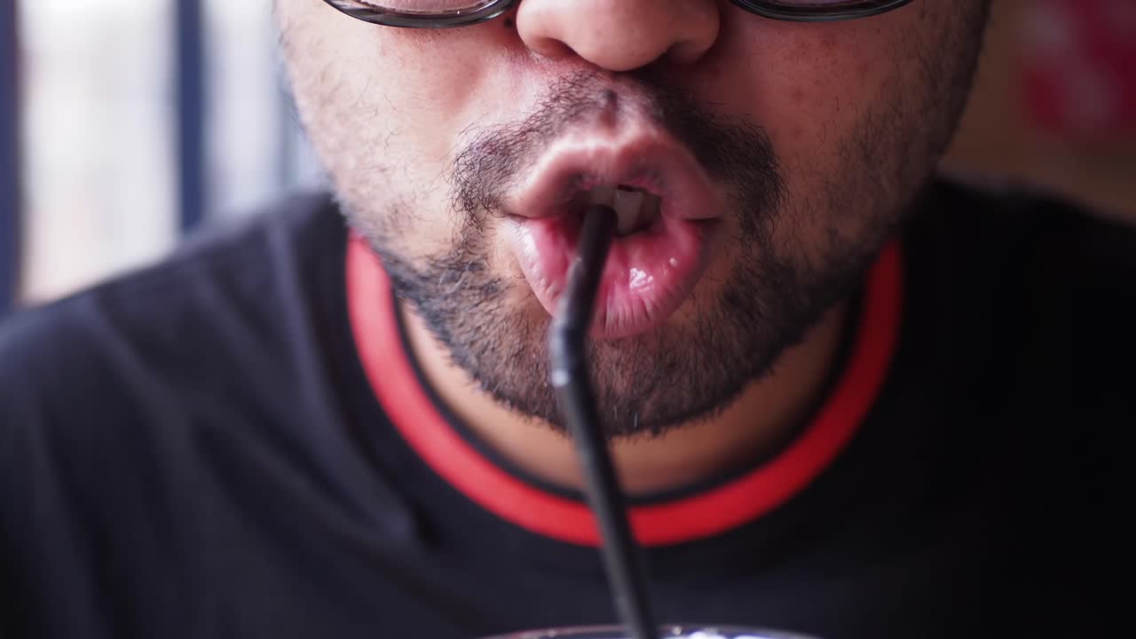 Person drinking from a straw