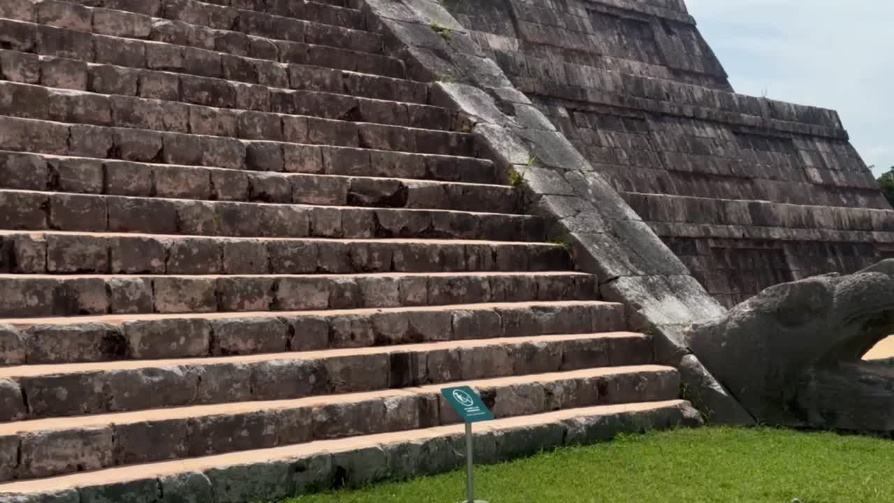 Handheld close-up panning shot of the steep steps at the ancient Mayan pyramid of El Castillo in Chichen Itza, Mexico. 4K