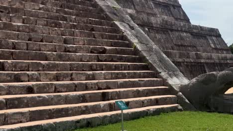 handheld close-up panning shot of the steep steps at the ancient mayan pyramid of el castillo in chichen itza, mexico. 4k