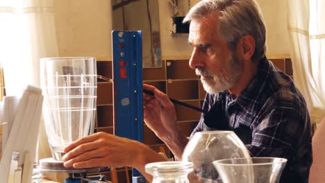 glassblower working on a glass vase