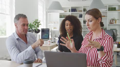 colleagues discussing about something on the computer