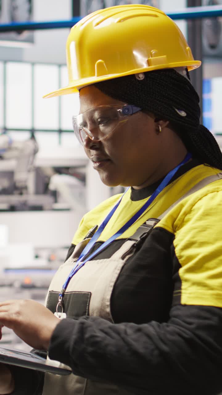 Vertical video Smart factory specialist typing on laptop keyboard, testing automated systems