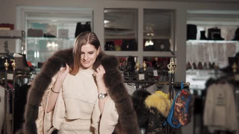 woman trying on winter coats in a boutique