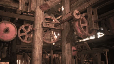 rustic gears and machinery inside an old wooden workshop in the afternoon