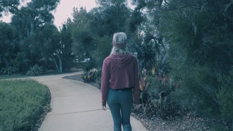 beautiful woman walking through bush land in australia