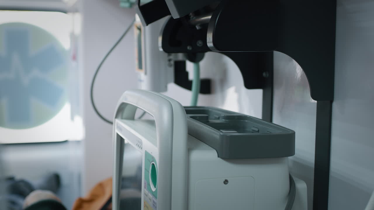 Paramedic Connecting Medical Equipment in Ambulance