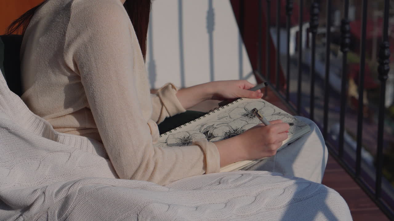 Woman Drawing Flowers on a Balcony