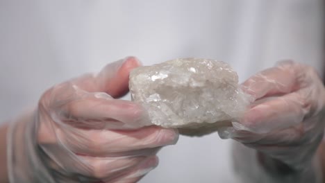 person holding a rock sample in gloves