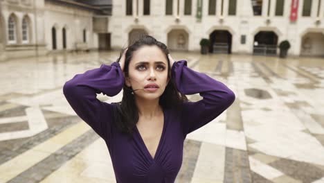 middle eastern young attractive woman is looking desperate in the sky while holding her head depressed lost slowmotion