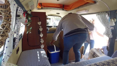 smiling family getting into a camper van, shot on r3d