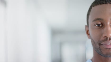 Portrait-of-happy-african-american-male-doctor-smiling,-copy-space,-slow-motion