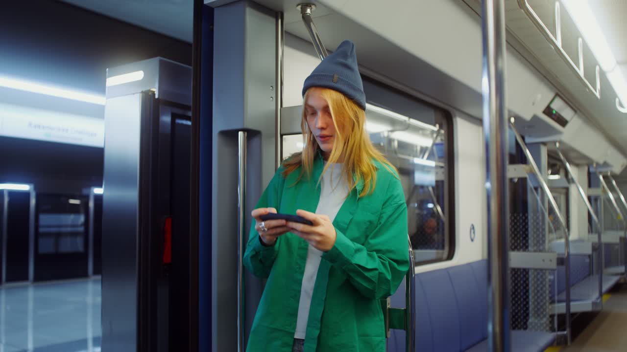 Woman using smartphone in metro station