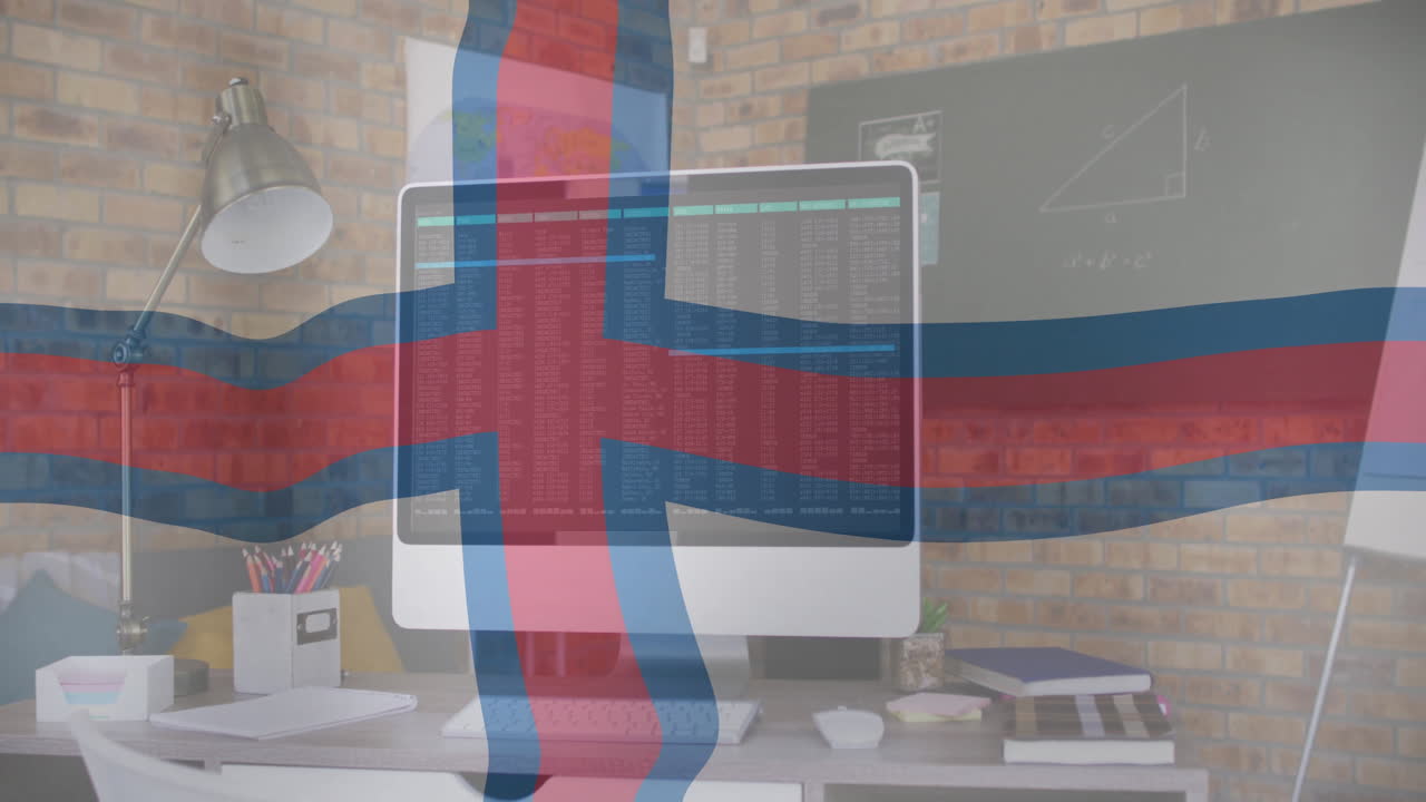 Displaying Faroese flag, computer screen showing code in home office setup