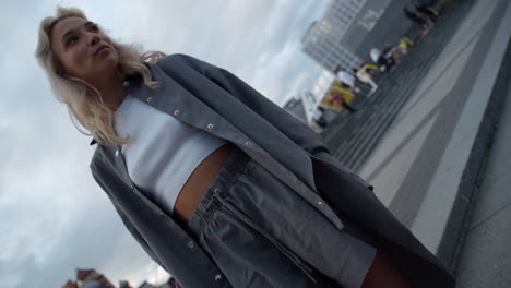 Female-model-street-posing-in-city-downtown-with-modern-architecture.