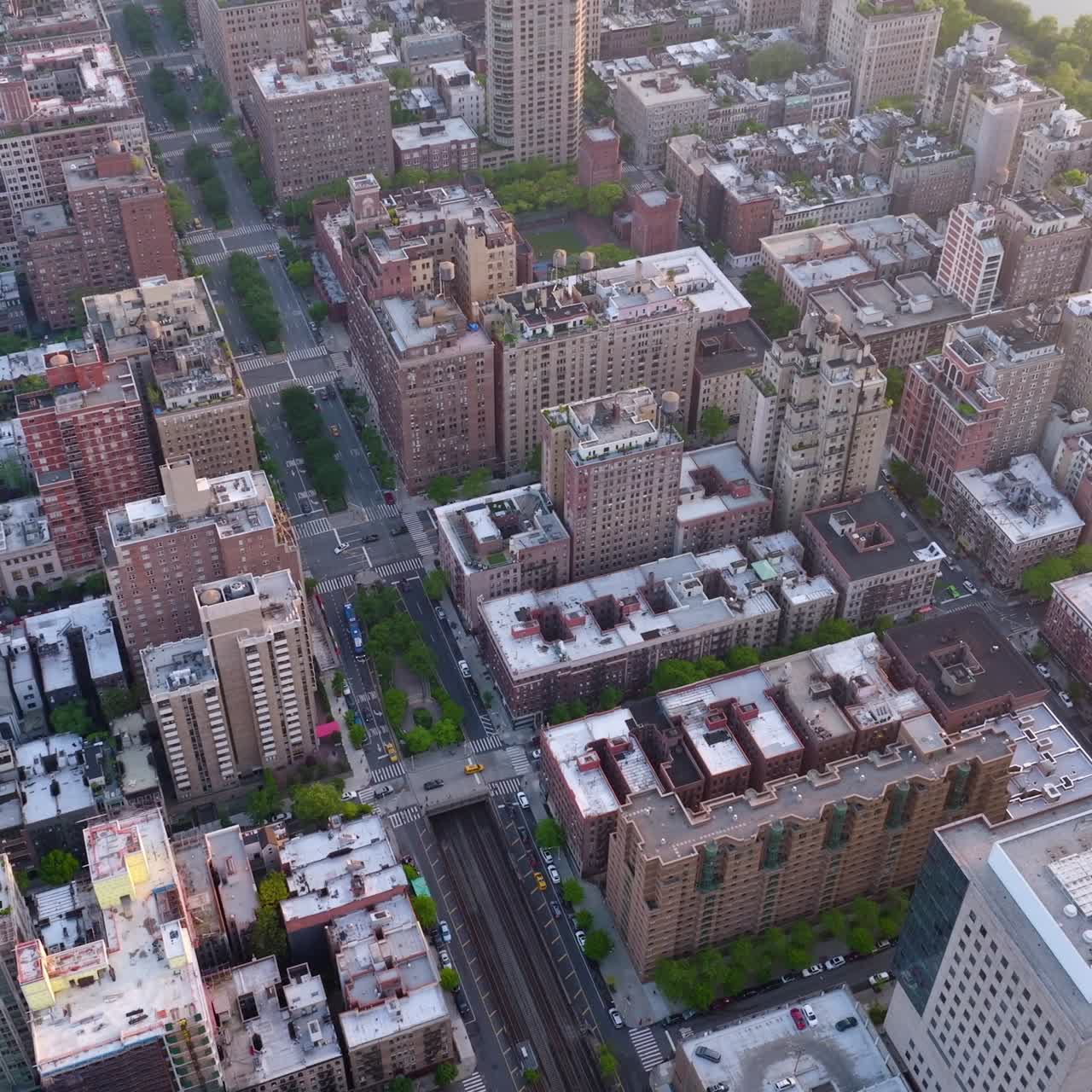 Multi-storied buildings of densely-built quarters of metropolis. Busy city at daytime. Aerial perspective