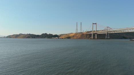 Coastal winds ripple the bay as a drone captures the Alfred Zampa Memorial Bridge in motionless detail from a Crockett vantage point