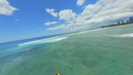 adventure awaiting, drone shot over turquoise blue waters of waikiki beach in oahu, hawaii, surfers and paddleboarders enjoying the outdoors