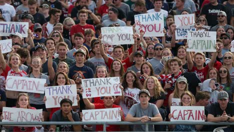 a heartfelt tribute: fans unite to show support for their captain with enthusiastic signs during an exciting event