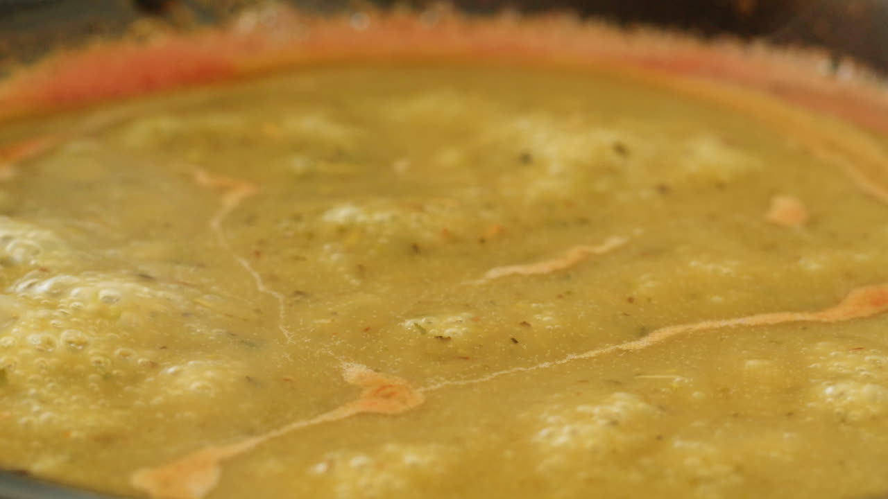 Cooking traditional Indian meal Palak Panir with spinach and cheese close up. Palak paneer is an Indian dish, consisting of paneer in a thick paste made from pureed spinach, Palak paneer is prepared by first boiling and pureeing spinach.