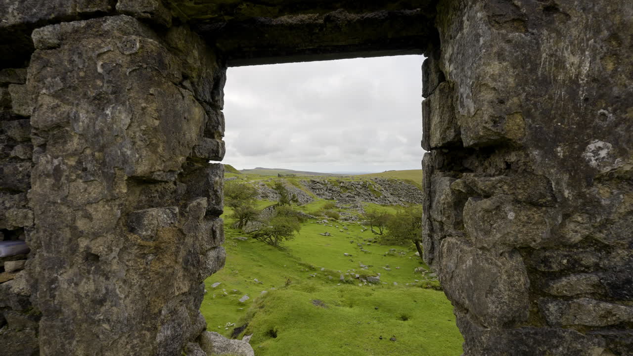 Girl looking out from ruins of an old stone building
